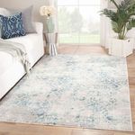 Siena Damask rug placed in a living room setting with sofa, pillows, and plants by a window