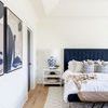 Layers Of Blue II displayed on wall in bright bedroom with navy bed and white nightstand