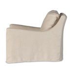 Opposite side profile of swivel chair showcasing slipcover texture and cushion fit
