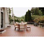 Outdoor patio with multiple Luce dining chairs around teak table set on terracotta tiles