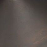 Close-up texture of dark bronze finish showing subtle warm undertones and matte surface