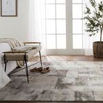 Rug styled in a bedroom setting with natural light, bench, and shoes to emphasize room integration