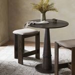 Goetz Bar + Counter Table styled in kitchen setting with cushioned wooden stools and decorative vase