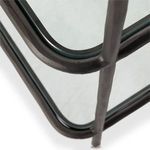 macro shot of curved gunmetal joint and tempered glass shelf corner with hammered texture