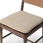 Woven paper cord backrest with intricate linear pattern in warm honey color