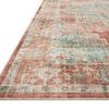 Close-up angled view showing textured pile and detailed terracotta and aqua medallion border