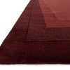 Close-up angle showing thick wool pile and texture of graduating red borders on Hamilton Red Rug