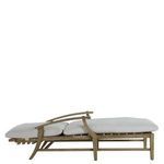 Close-up of white cushioned backrest cushion strapped to natural teak wood frame