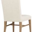Back view showing fully upholstered bisque fabric backrest and oak legs with stretcher bars in Buckboard finish