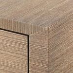 Close-up of dresser's corner seam highlighting earthy brown textured pattern
