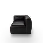 Side profile of sectional highlighting thick cushions and squared armrest with brown stitching