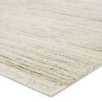 Close-up of rug corner showing dense, soft wool fibers and hand-loomed texture with subtle color variations