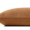 Side view of Harvey Orange Pillow showing smooth solid cotton fabric on back and textured woven front