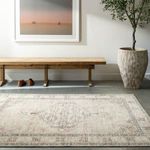 Lila rug shown laid flat in a modern entryway with wooden bench, shoes, and potted plant