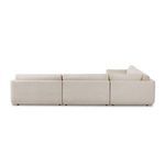 Corner view of Toland sectional showing fitting of seat and back cushions in cream basketweave fabric