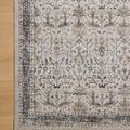 Top corner view showing part of rug on a light wooden floor highlighting embroidered design