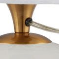 Detailed view of the lamp’s power cord entering the base through the brass neck