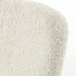 Back view of Caleb Small Ivory Angora Accent Chair highlighting black metal structural strap