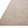Close-up angled view of the rug's textured edge and subtle color variations in oatmeal and slate hues