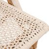 Close-up of woven rope texture on the chair’s seating surface with natural color accents
