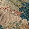 Close-up on beige and green woven fabric highlighting detailed building and foliage in tapestry pattern