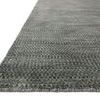 Close-up of deep gray Elliot Granite Rug corner showing dense, patterned pile and finished edges
