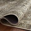 Folded edge of Layla rug showing thin profile and detailed woven border on hardwood floor