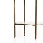 Close-up of antique brass iron frame leg supporting marble shelf