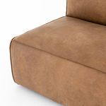 Close-up of sofa seat cushion edge with fine top-stitching and natural leather patina