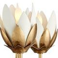 Close-up of gold and white blossoms with layered petal detailing and lit bulbs inside
