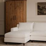 Hutton sectional in living room setting with wooden armoire and warm neutral decor