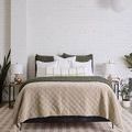 Full bedroom view with bed dressed in dark olive Murphy Pillows, white and plaid pillows, beige quilt, and modern minimal ...