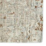 Close-up of rug surface highlighting the dense, looped texture and abstract bronze accents