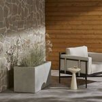 Second outdoor patio view of planter styled with plants next to seating area and wood siding