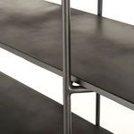 Brass-capped leg and shelf corner detail highlighting industrial design craftsmanship