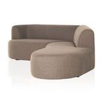 Sectional viewed from an angled front side highlighting rounded chaise extension.