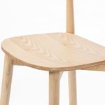 Close-up of seat edge showing layered ash veneer and delicate wood grain pattern