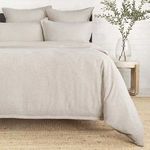 Natural beige Georgie duvet on bed with subtle texture, paired with matching pillow shams in minimal bedroom setting