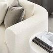 Close-up showing the textured Itilia Ivory upholstery fabric and throw pillows on Lola Sectional armrest