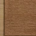 Kai Terracotta Rug corner on wood floor highlighting ribbed pattern and edge finish