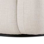 Close-up capturing fabric texture and stitching on chair’s backrest corner
