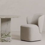 Chair positioned next to marble dining table in minimalistic room setting