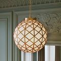 Softly glowing pendant with visible suspension chain and antique brass rim near room ceiling