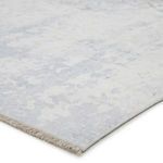 Close-up of rug edge showing low profile and subtle soft blue and white texture