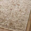 Close-up on woven border and faint vintage-inspired fading effect of rug on wood floor