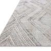 Low angle view highlighting the flat weave and subtle texture of the geometric pattern on the rug