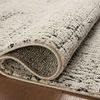 Focus on rolled edge of rug displaying thickness and underside texture