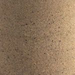 Close-up of speckled clay texture on mug surface with fine natural variations