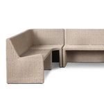 View of rattan outdoor bench side showing continuous wicker weave over structure