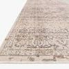 Rug angled low showing pile height and dimensional pattern with beige and grey tones